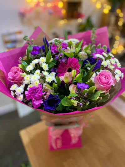 Sugar Plum - A gorgeous handtied in water presented in a gift box , created using the fresh blooms of the day in pink, purple and white with complementary foliage
